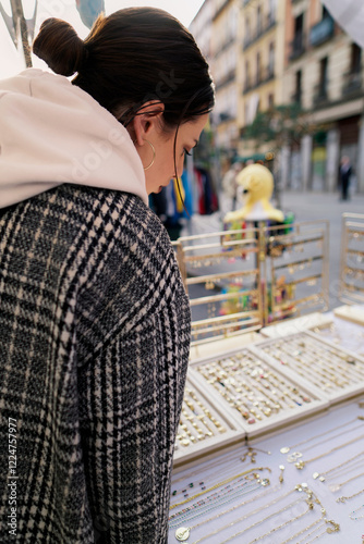 Woman choosing jewelry at el rastro flea market in madrid