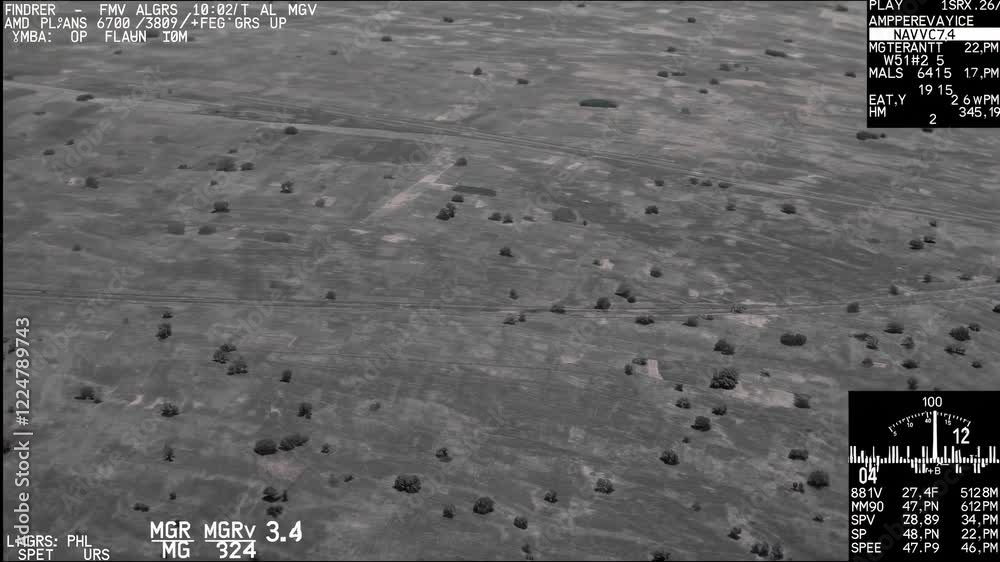 Monochrome aerial surveillance footage presents a segmented view of a landscape, accompanied by various flight parameters and data points displayed on an overlay