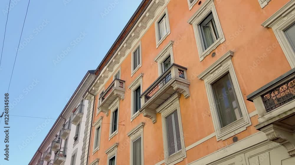 Bottom view of traditional, historical, typical buildings in Milan. It shows Italian architectural style. Bottom view of traditional, historical, typical buildings in Milan. It shows Italian architectural style.