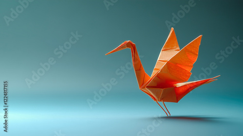 Orange origami crane standing on a gradient blue background photo