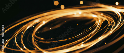 Whirling gold confetti creates a dynamic swirling effect against a black background photo