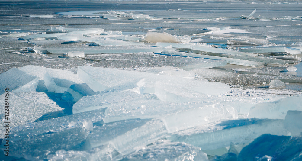 Fototapeta premium Large chunks of ice on the shore of a frozen lake
