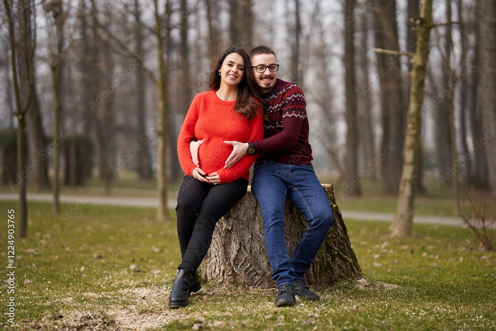 Fototapeta premium Expecting couple embracing outdoors