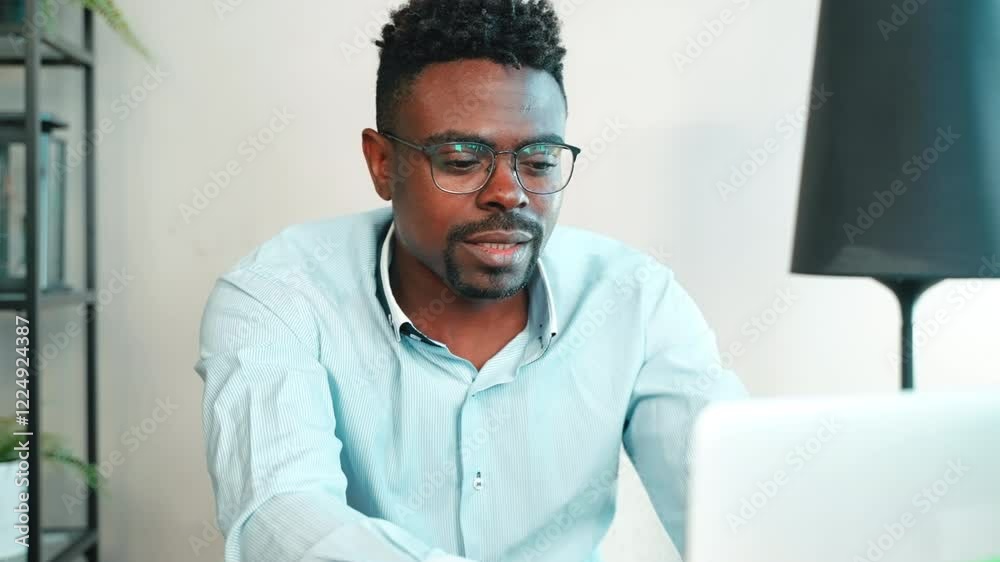 Man has video call on laptop in office. Man has video call on laptop in office.