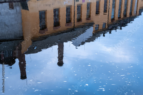 Reflection of Historic Building in Rippling Water photo