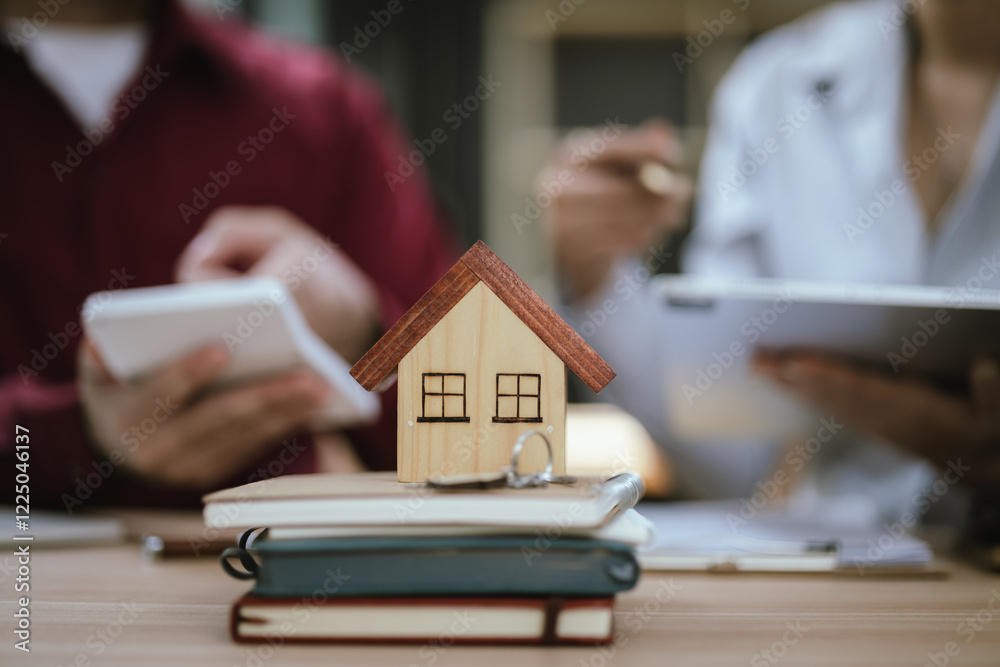 Fototapeta premium Real estate agent hands keys to new homeowner, symbolizing successful home purchase. Documents, contracts, home ownership, and real estate transactions.