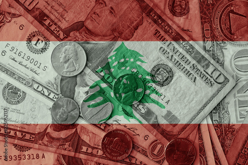 colourful flag of lebanon on a dollar money banknotes and coins background. finance concept. macro shot photo