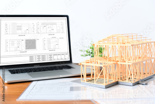 建築模型とノートPCと建築図面のイメージ