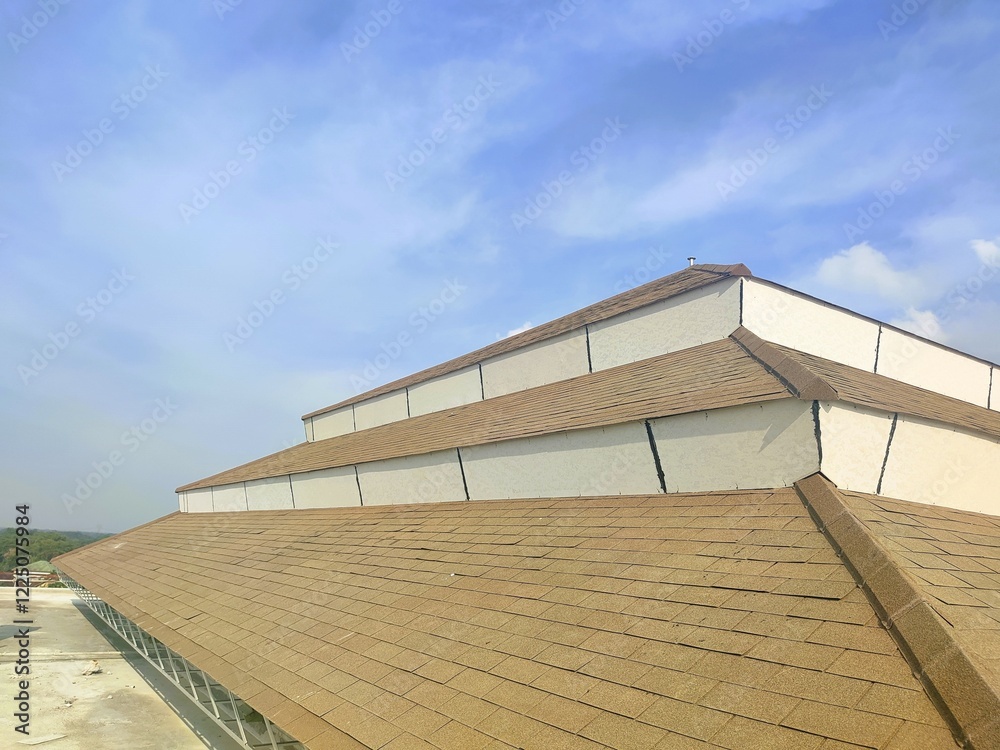 Damaged shingle roof with visible gaps and wear, highlighting structural vulnerability under a bright and partly cloudy sky Damaged shingle roof with visible gaps and wear, highlighting structural vulnerability under a bright and partly cloudy sky