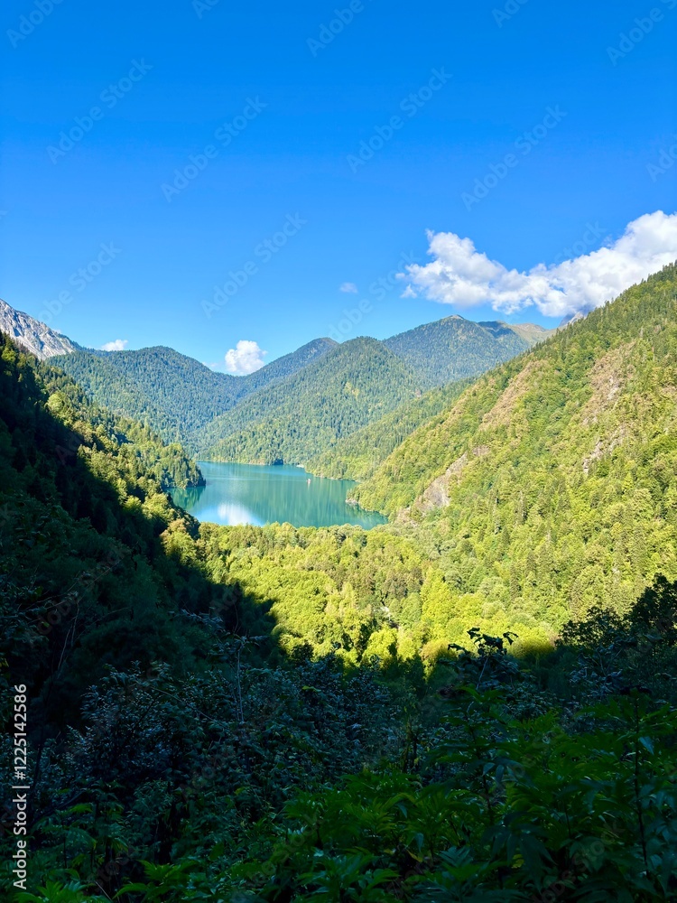 Obraz premium Abkhazia, Gudauta district, September 26, 2024. Bright colour image picturesque mountain lake Ritsa in Abkhazia. The beauty of nature