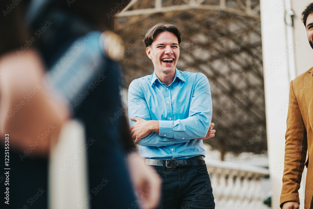 Fototapeta premium A group of business people sharing a laugh in an outdoor city area. The joyful scene captures positive office culture and team camaraderie, highlighting the human side of corporate environments.