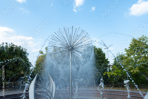 Water rising and falling, symbolizing life and constant movement. A city fountain in the park — a place for inspiration and relaxation. photo