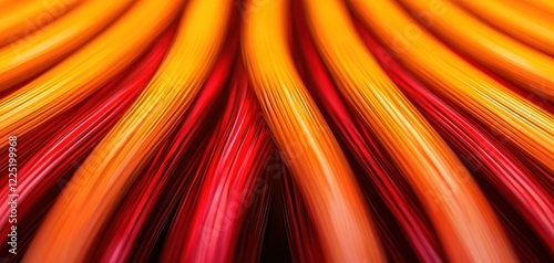 Fiber optic data concept. A vibrant, abstract image featuring flowing lines in shades of red, orange, and yellow, resembling waves or ribbons.