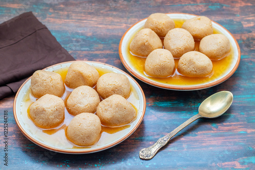 Delightful Nolen Gurer Rosogolla, The Rich, Aromatic Bengali Dessert Infused with Date Palm Jaggery, A Timeless Culinary Treasure photo