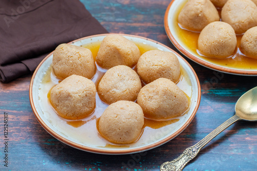 Delightful Nolen Gurer Rosogolla, A Sweet Bengali Tradition with Rich Flavors and Unique Date Palm Jaggery Essence photo