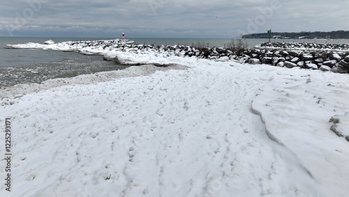 Winter scene with snow and ice along Lake Ontario, NY with Irondequoit Bay Pier  photo