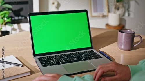 Woman hands using touchpad green screen laptop at home closeup. Unknown female