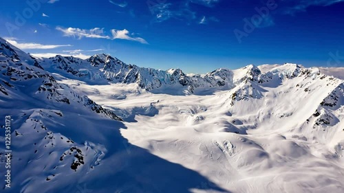 Wallpaper Mural High-contrast aerial shot during midday, focusing on long shadows cast by sharp peaks and ridges over untouched snowy plains Torontodigital.ca