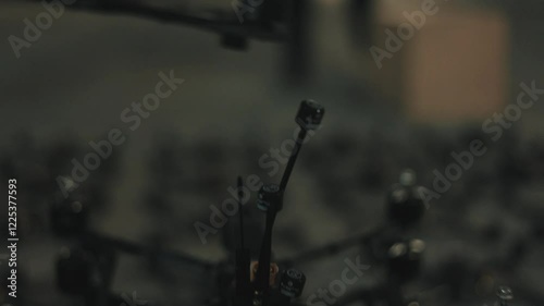 Young people lay out fpv drones and quadcopters on the floor.