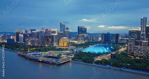 Aerial shot of the Hangzhou skyline at dusk with illuminated buildings