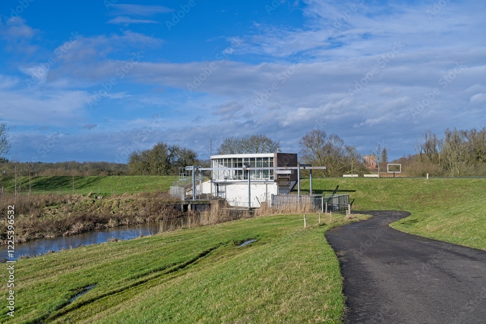Gemaal Middelbeek on the dike on the river IJssel with castle ruins Nijenbeek in the background. Gemaal Middelbeek on the dike on the river IJssel with castle ruins Nijenbeek in the background.