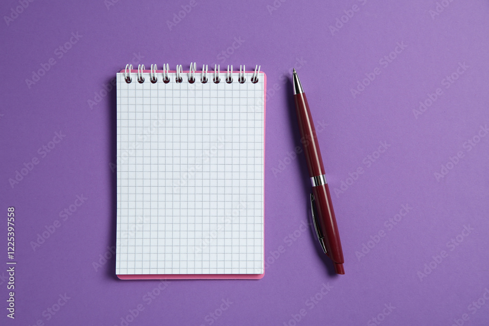 Blank notebook and pen on purple background, top view. Space for text Blank notebook and pen on purple background, top view. Space for text