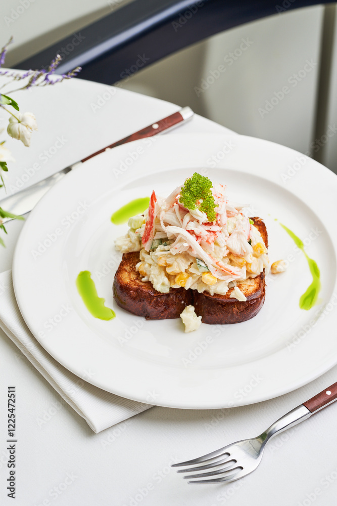 A gourmet dish featuring toasted bread topped with a delicate seafood mixture and vibrant herb sauce, elegantly presented on white china A gourmet dish featuring toasted bread topped with a delicate seafood mixture and vibrant herb sauce, elegantly presented on white china