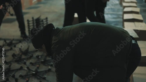 Young people lay out fpv drones and quadcopters on the floor.
