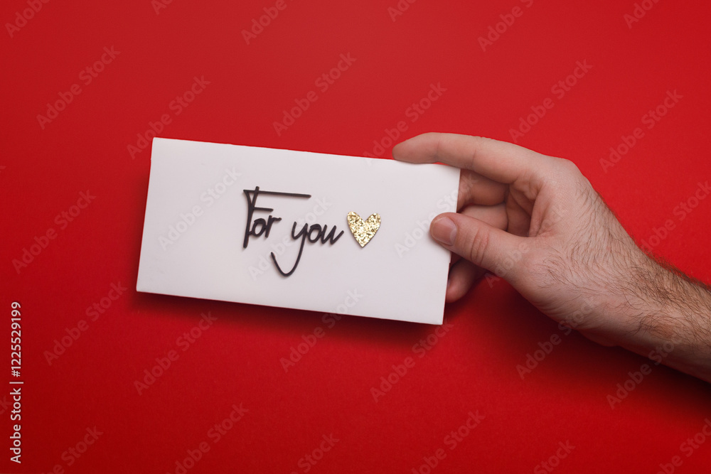 man holds a white envelope with the words man holds a white envelope with the words