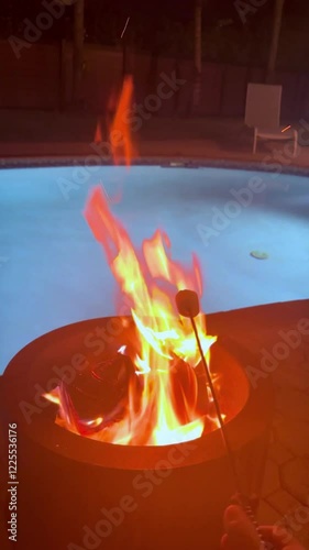 Bonfire by a pool with marshmallows roasting