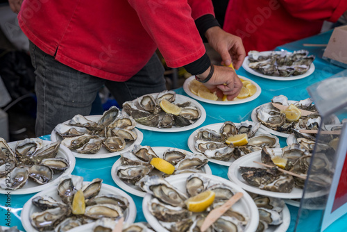 Tasting fresh oysters with lemon at a vibrant seafood festival