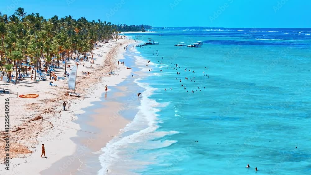 Best beaches in the world. Top view of a hotel beach of tropical islands on the shores of the blue sea. Dominican Republic, Punta Cana. White sand, beautiful beach, tall palms. Relax on blue sea water