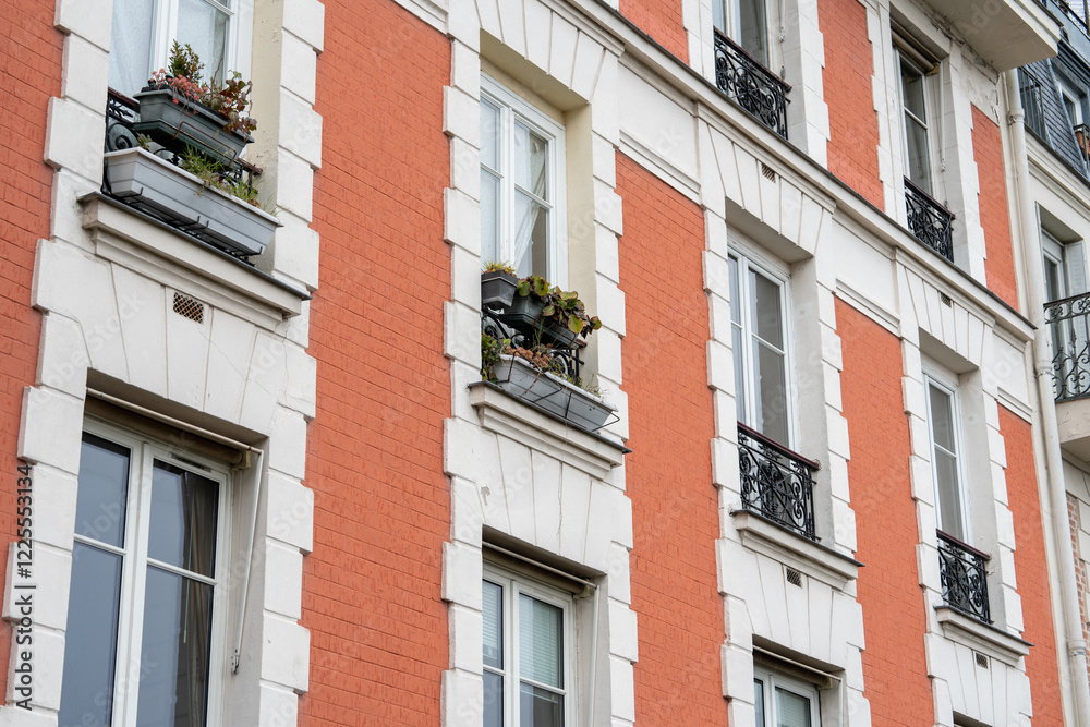 Charming urban facade showcasing colorful flowers in balcony pots Charming urban facade showcasing colorful flowers in balcony pots