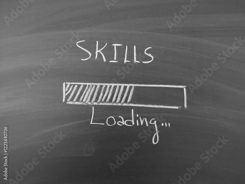 Skills loading shown on blackboard with chalk writing, depicting personal and professional growth and education concept.