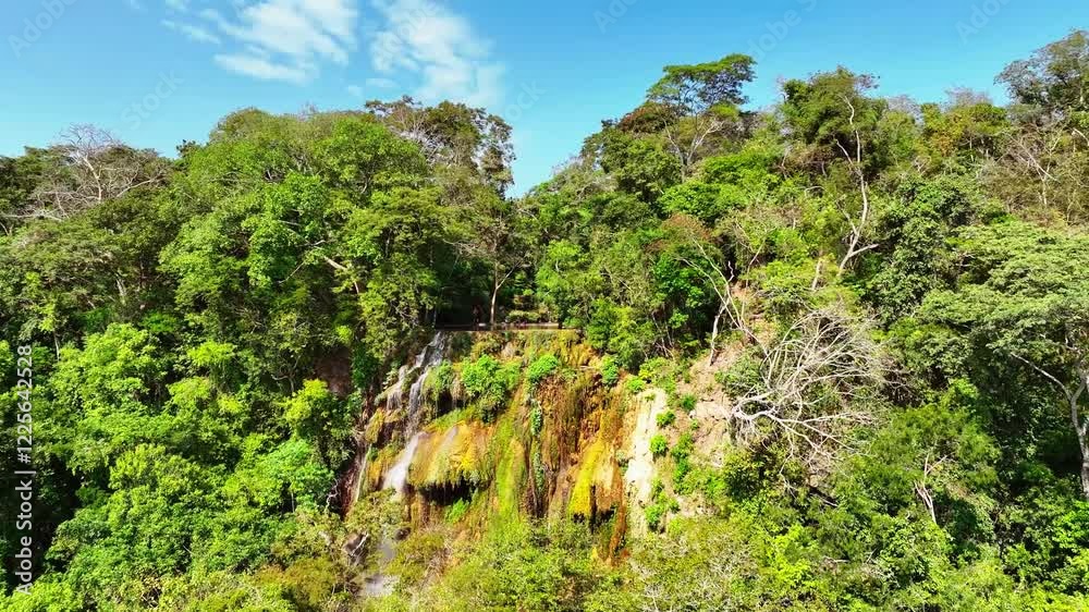 Aerial view of lush cascading waterfall surrounded by vibrant greenery and tropical forest, Bodoquena, Brazil. Aerial view of lush cascading waterfall surrounded by vibrant greenery and tropical forest, Bodoquena, Brazil.