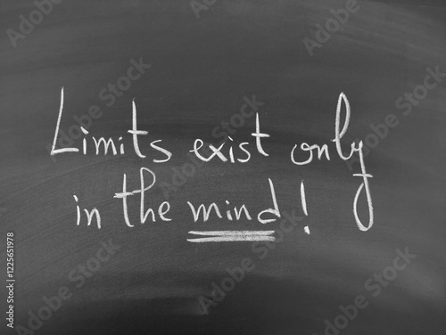 motivational quote handwritten in white chalk, reading 'Limits exist only in the mind!'