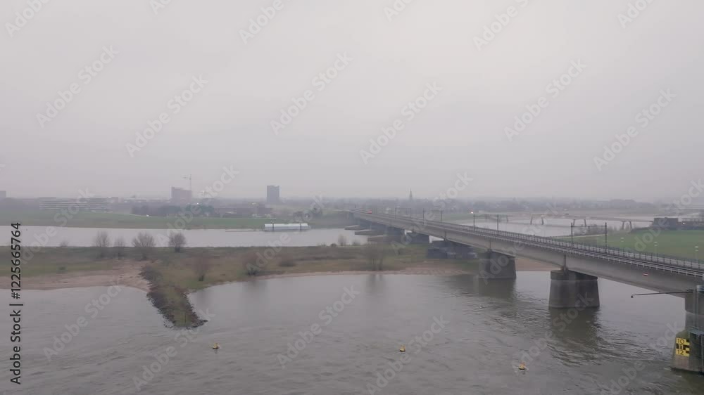 Aerial view of Spoorburg railway bridge over the river in a serene cityscape, Nijmegen, Netherlands. Aerial view of Spoorburg railway bridge over the river in a serene cityscape, Nijmegen, Netherlands.