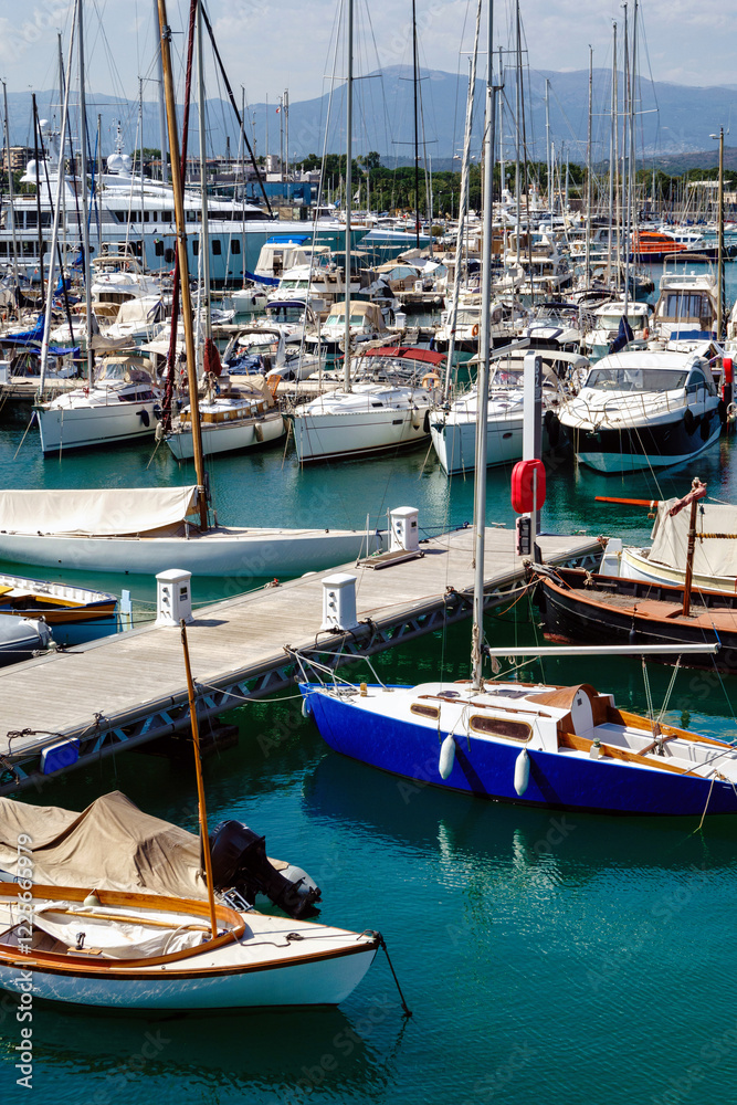 Port with boats in Antibes, summer day at the sea, white blue clouds