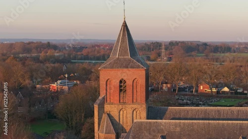 Aerial view of the historic sint-martinuskerk church and tranquil countryside at sunset, Oud Zevenaar, Netherlands. photo