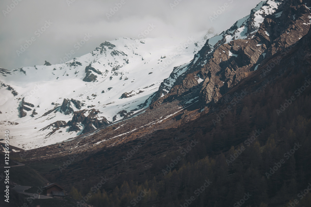 Close-up of one mountain cliff lightly dusted with snow against a clear sky. Mountain landscape. The top of the mountain Close-up of one mountain cliff lightly dusted with snow against a clear sky. Mountain landscape. The top of the mountain