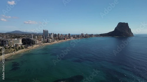 Aerial view of picturesque coastal cityscape with beautiful beach and serene sea, Calpe, Spain.