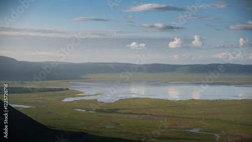 Scenic view of ngorongoro crater lake reflecting clouds and blue sky in tanzania, africa, a natural wonder and unesco world heritage site