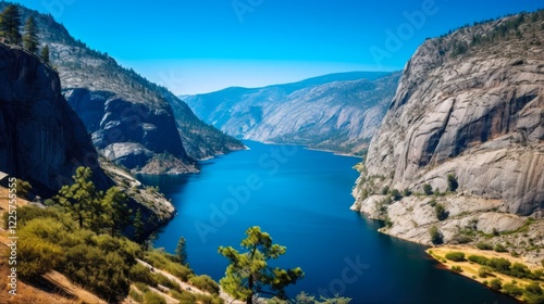 Hetch Hetchy Reservoir on a Beautiful Alpine Day in California's Sierra Nevada Mountains; Wapama and Tueeulala Falls Visible Across the Blue Lake photo