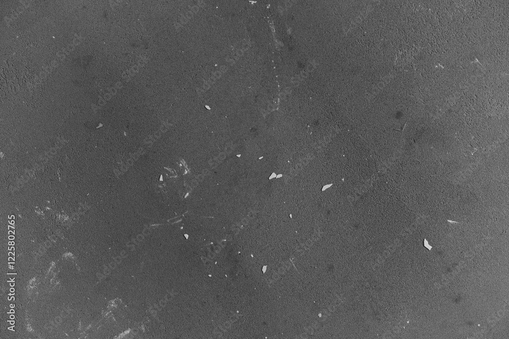 Fototapeta premium Dark textured surface with scattered fragments in a minimalist style