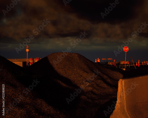 Obraz na płótnie Roadside construction area during sunset with a cloudy sky. 3D render. w salonie