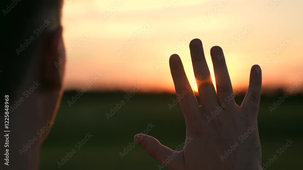 man against sunset, view from back man, man's hand glare sunset, hand glare sunlight, man prayer evening sunset, rays dawn through fingers, prayer God light ask forgiveness, rays dawn through God man against sunset, view from back man, man's hand glare sunset, hand glare sunlight, man prayer evening sunset, rays dawn through fingers, prayer God light ask forgiveness, rays dawn through God