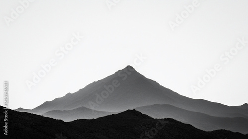 Wallpaper Mural Serene black and white mountain landscape with a prominent peak surrounded by soft hills at dusk Torontodigital.ca