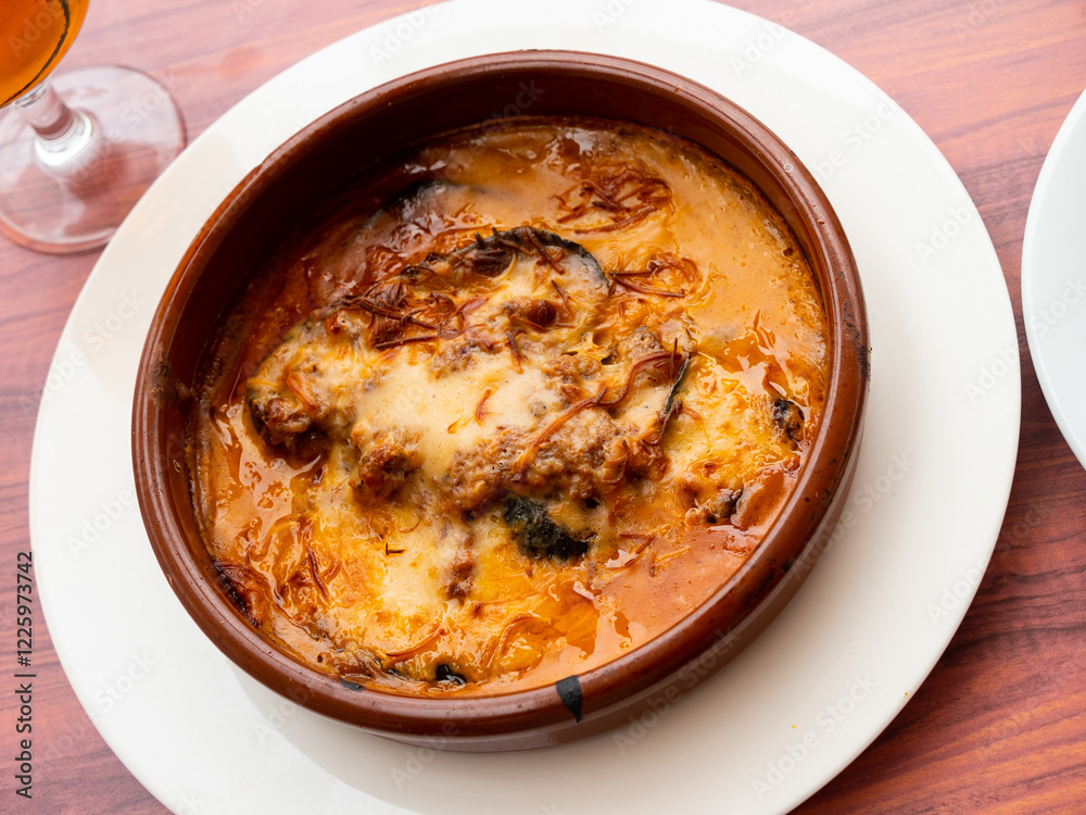 Just prepared appetizing moussaka with beef served on table. Just prepared appetizing moussaka with beef served on table.