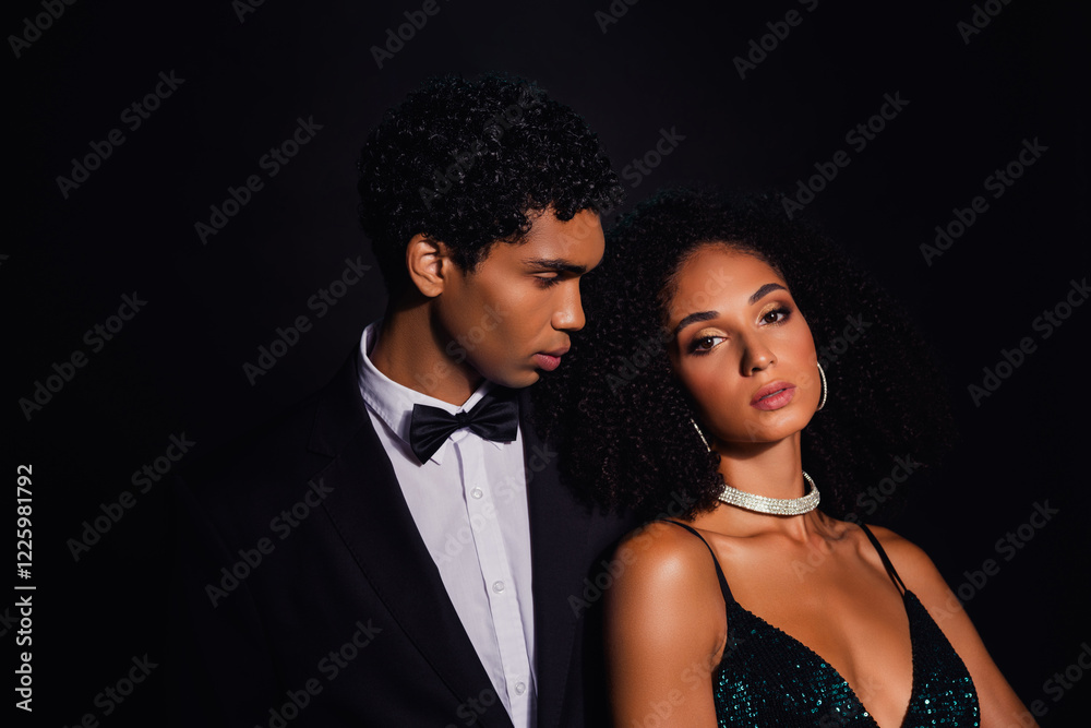 Elegant couple exuding luxury and style in a glamorous setting, captured against a dark backdrop. Elegant couple exuding luxury and style in a glamorous setting, captured against a dark backdrop.