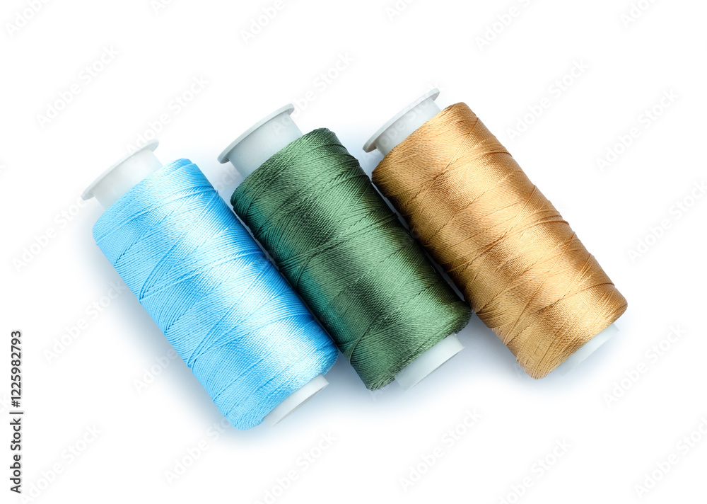 Spools of bright sewing threads isolated on white, top view Spools of bright sewing threads isolated on white, top view